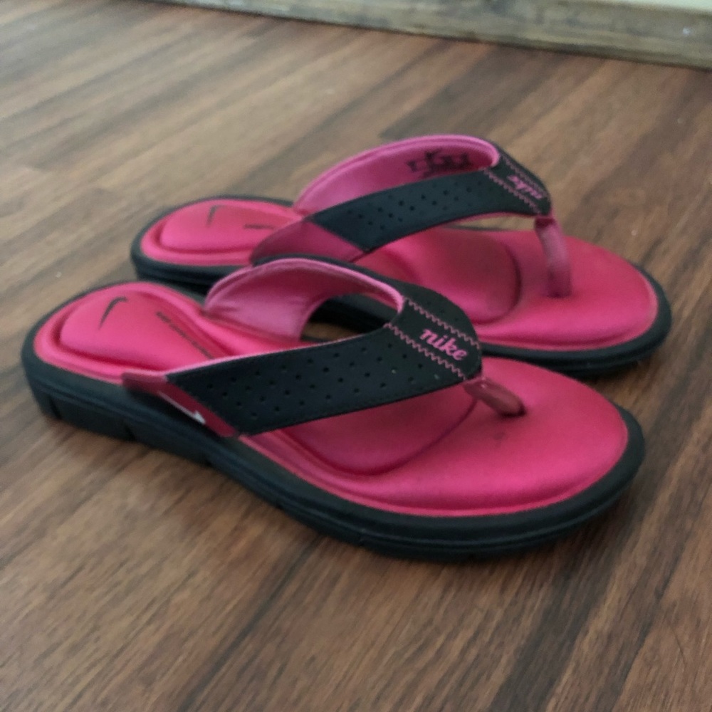 Hot pink and black Nike flip flops